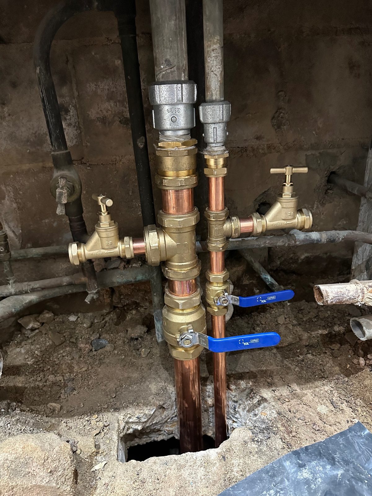 New copper pipework and valves fitted in place of a corroded pipe