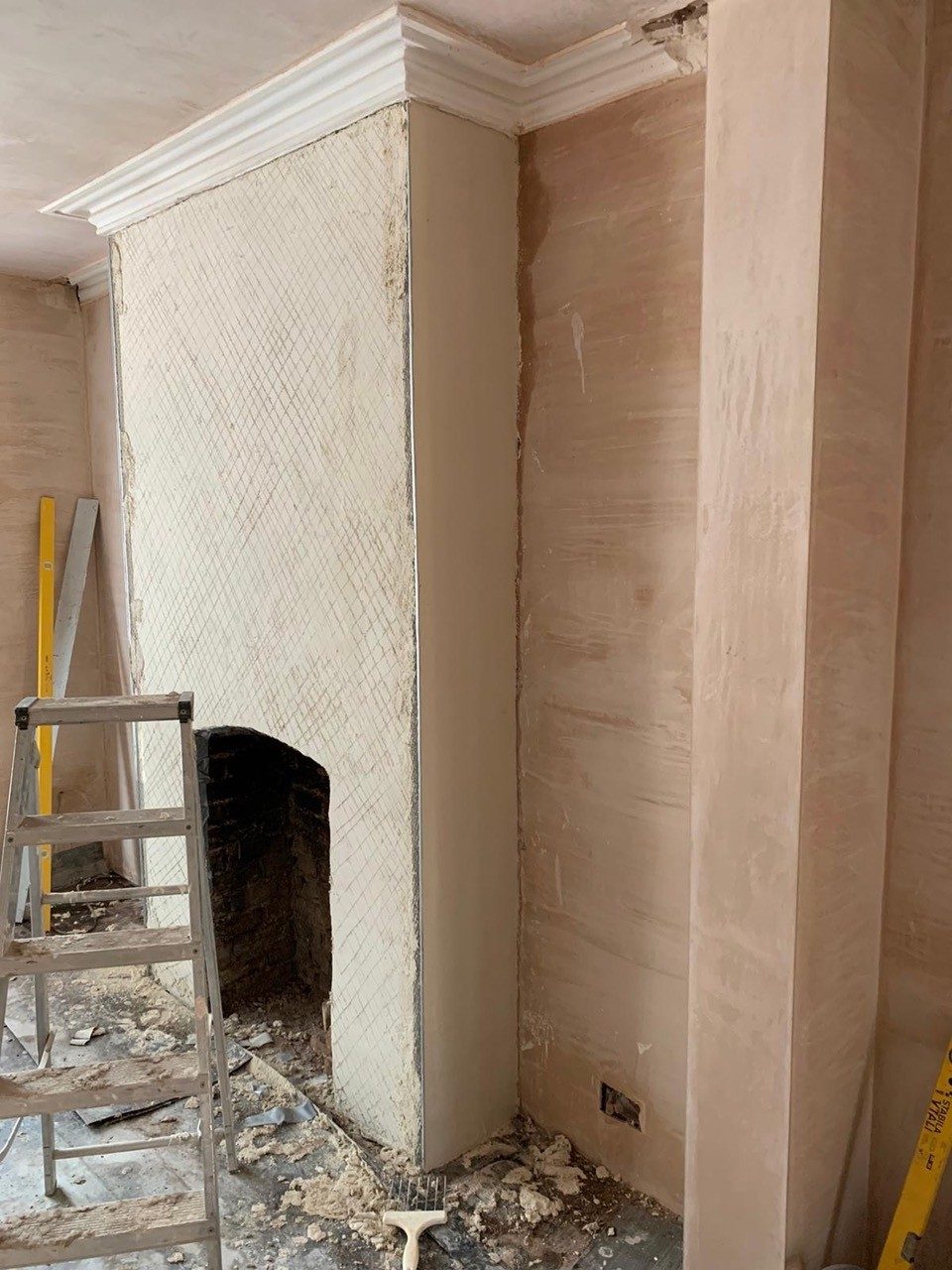 Chimney breast being replastered
