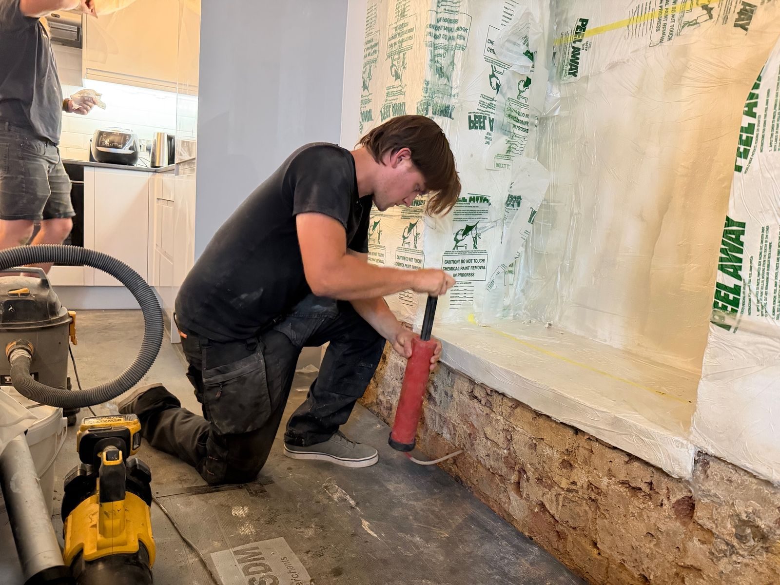 Injecting a damp-proof barrier along the base of the wall