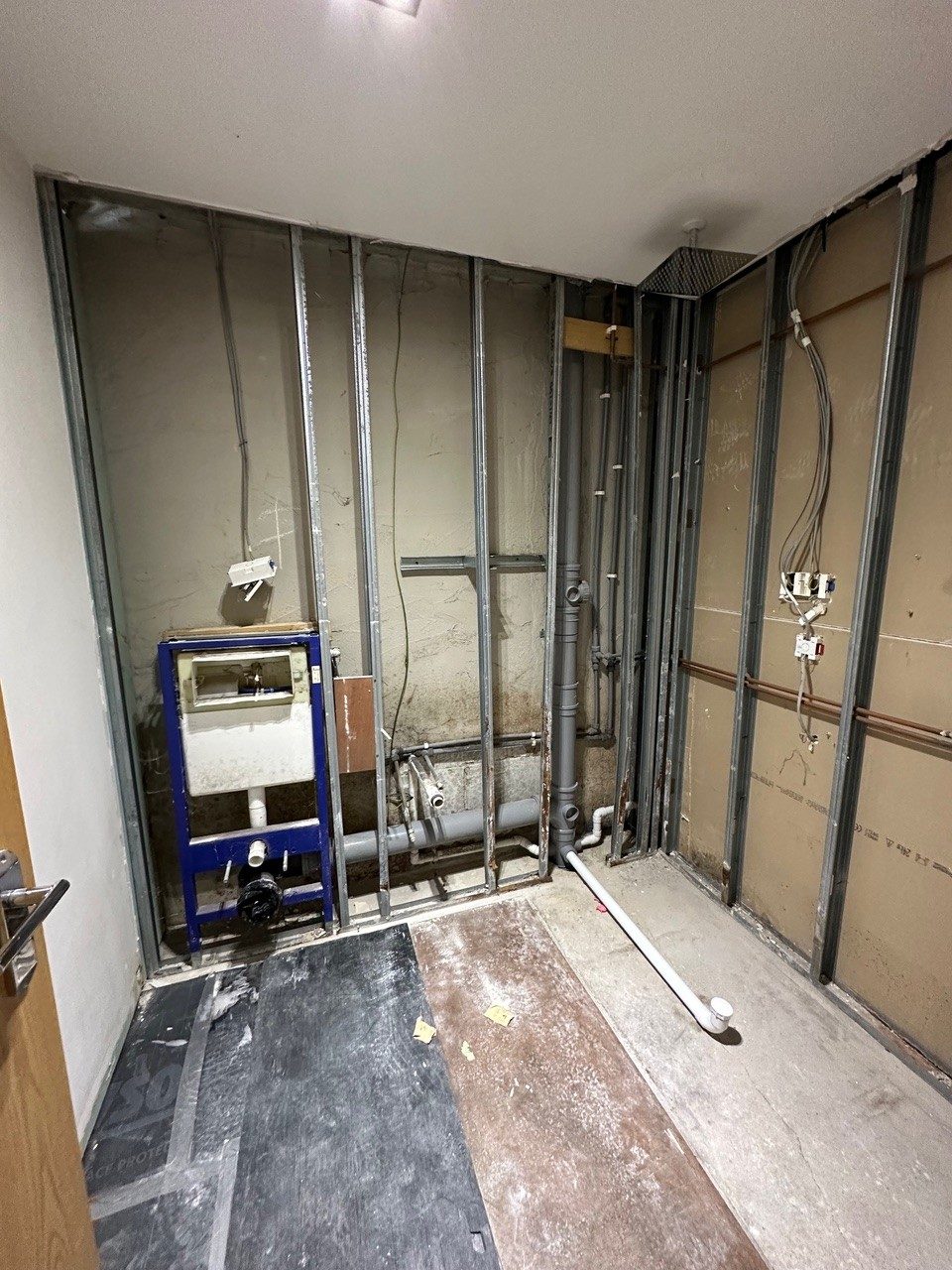 Bathroom stripped back to stud walls and new pipework