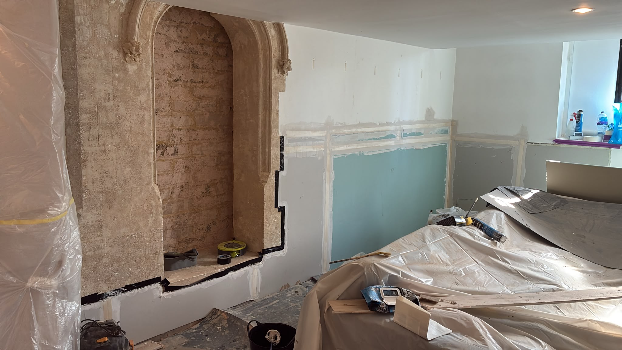 Walls dry-lined, taped and jointed, with the arch stonework uncovered