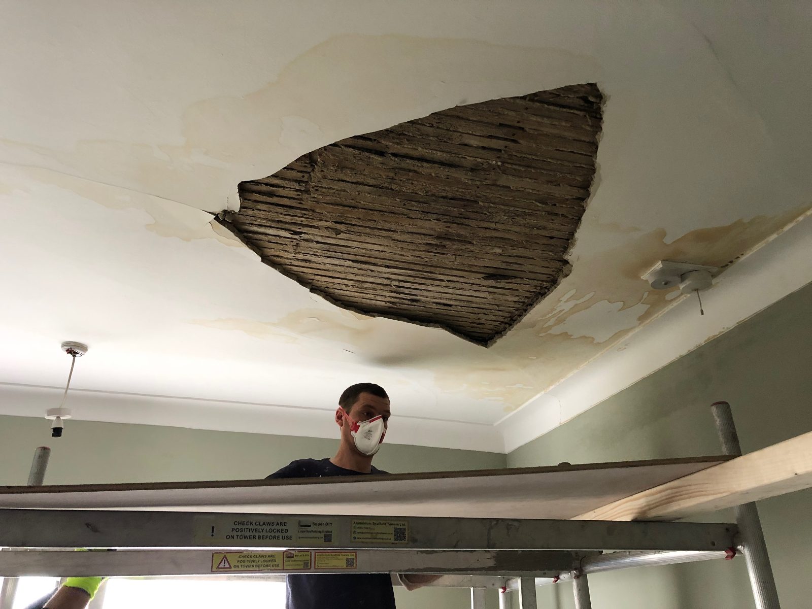 Ceiling brought down by a leak, with the laths exposed