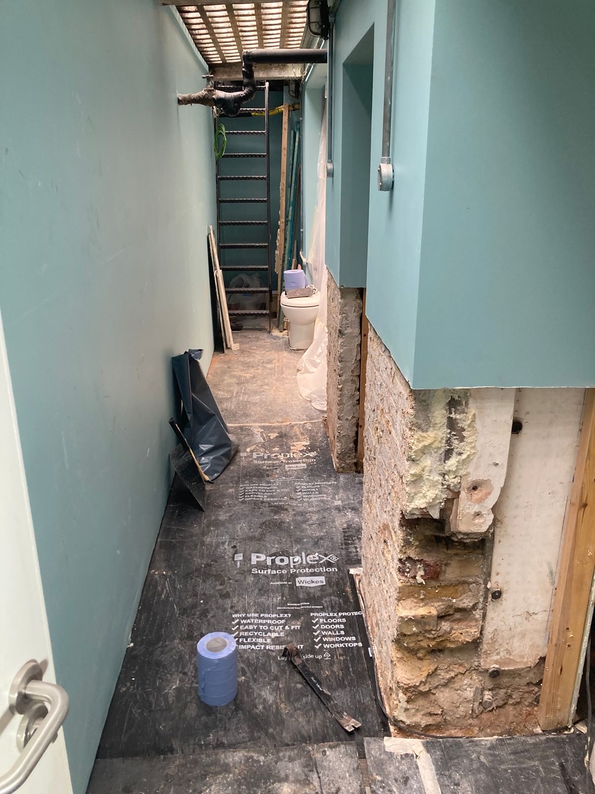 Damp render removed from the lower corridor walls