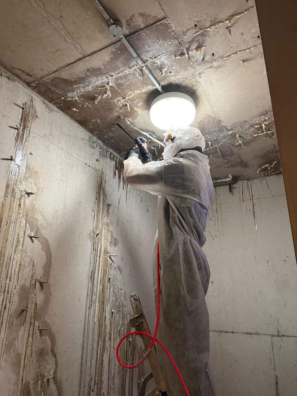Injecting resin into a basement's concrete to seal it against water