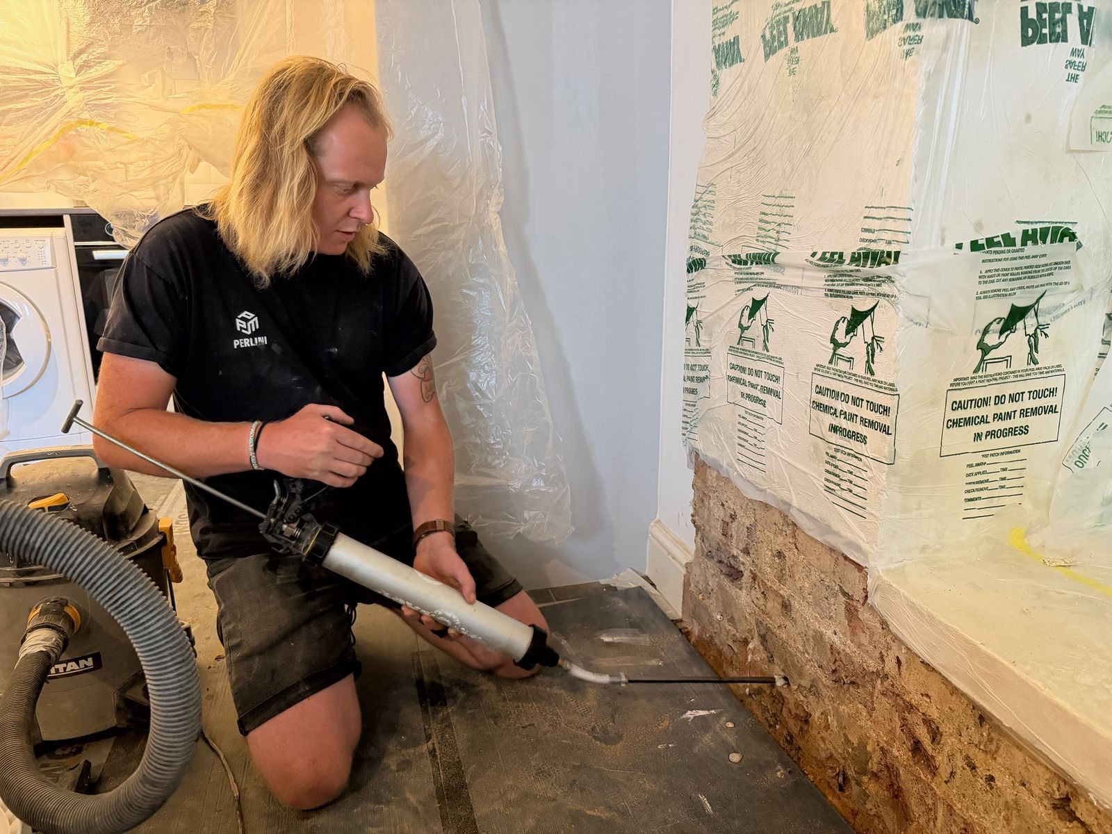 Injecting a damp-proof barrier at the base of a wall
