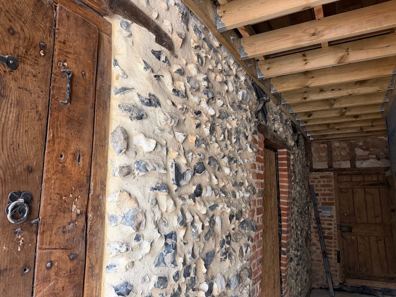 Restored flint wall and oak doors