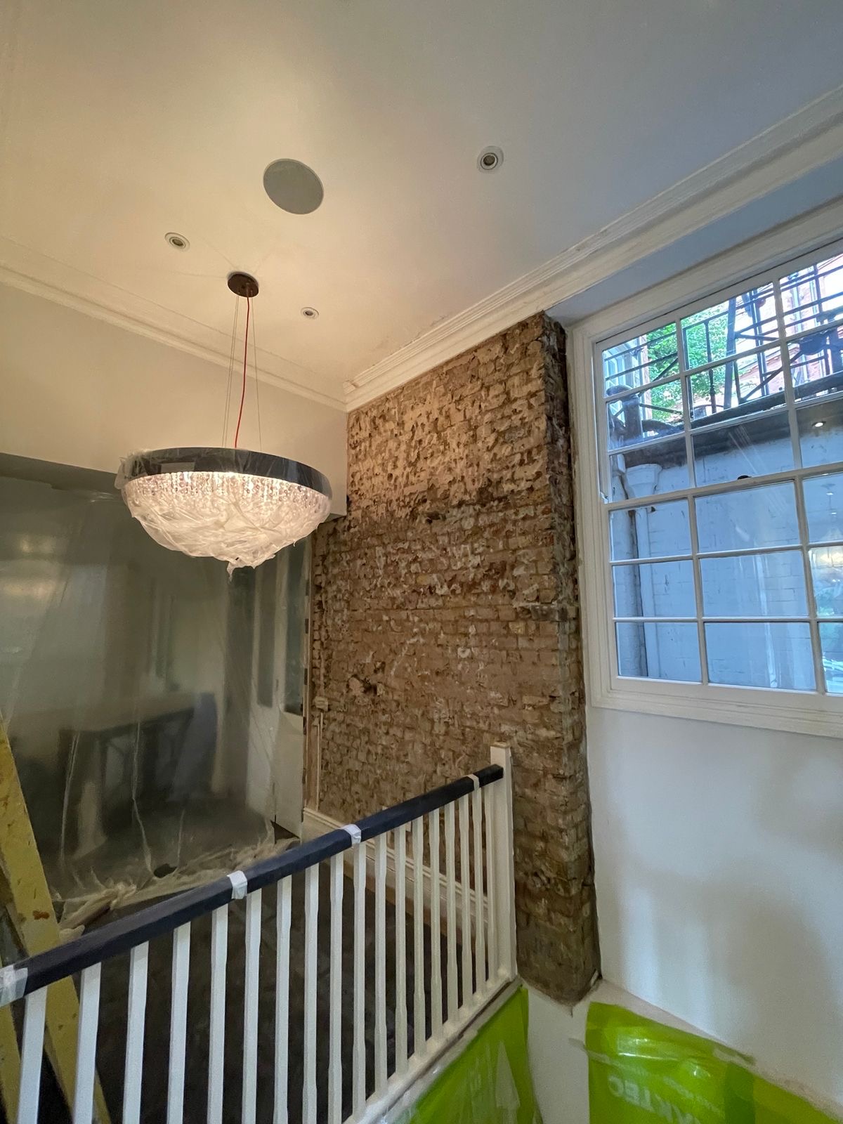 Damp render removed from the stairwell wall