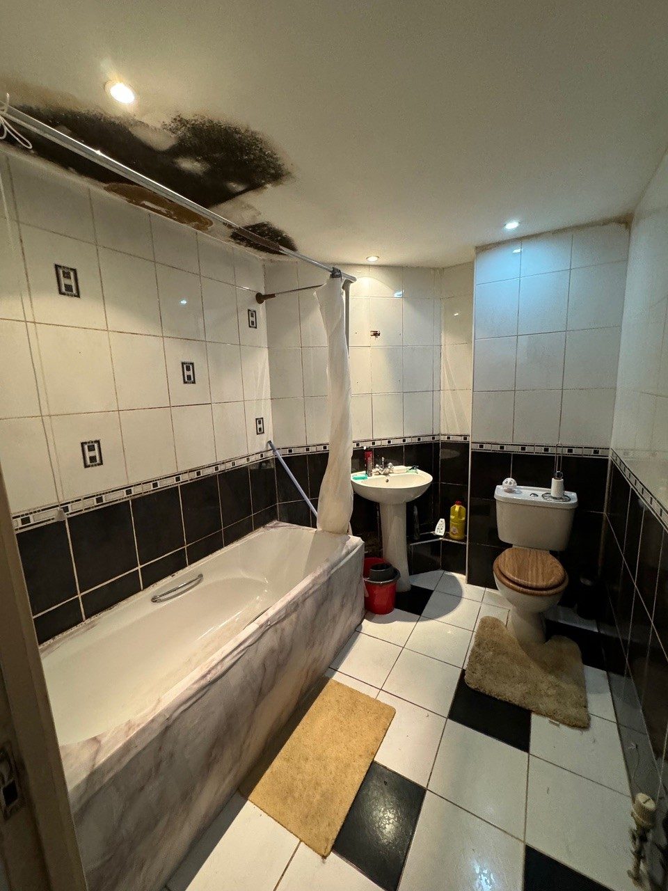 Bathroom ceiling damaged by a leak from the flat above