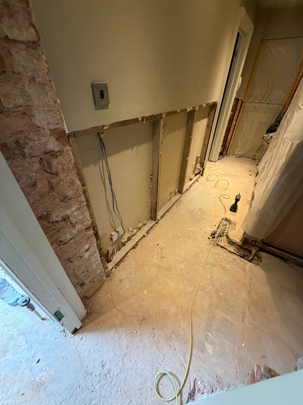 Damp render removed and floor opened up in the hallway