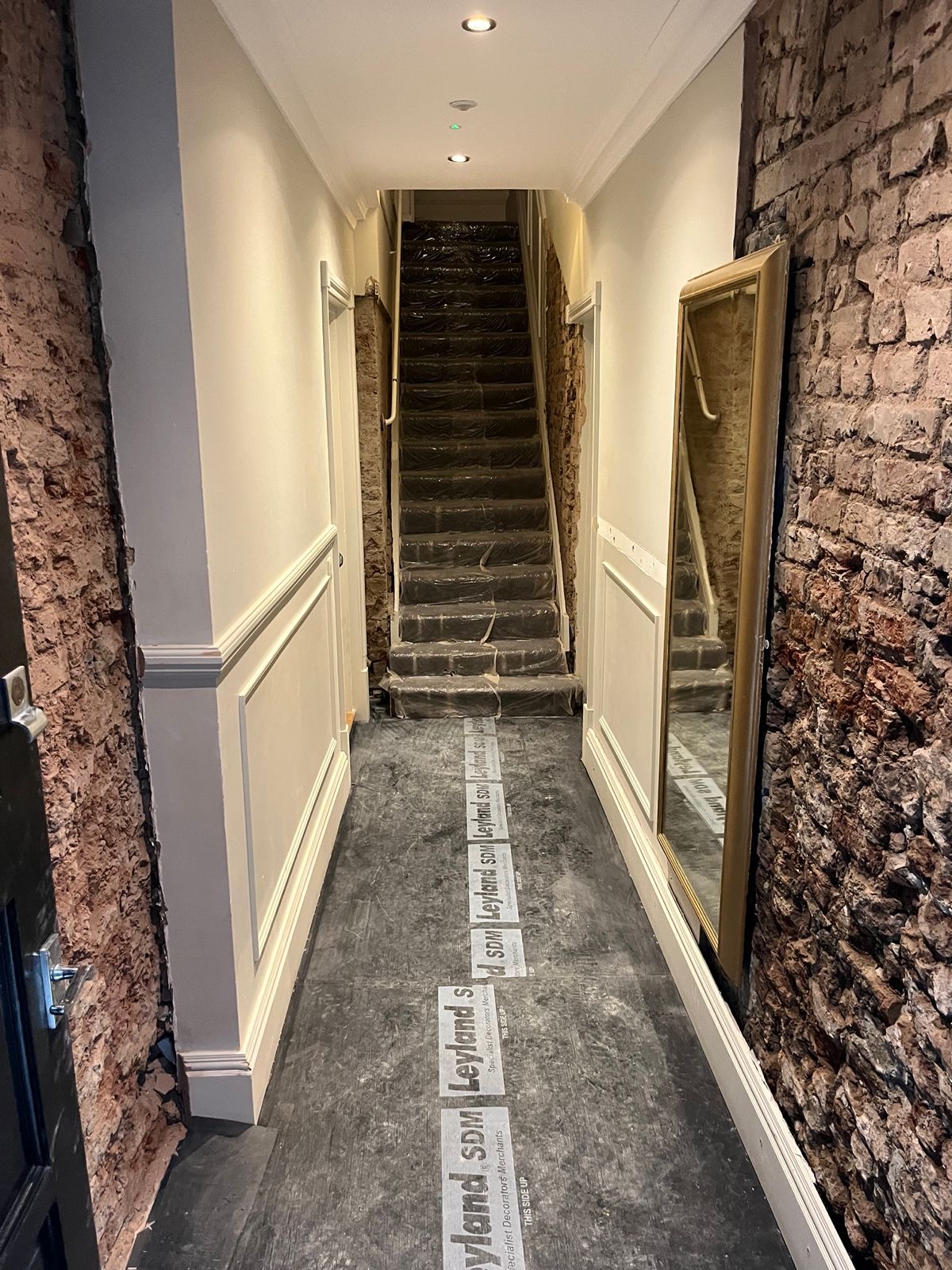 Damp render removed along the hallway and stairs